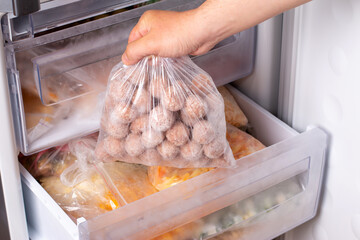 Semi-finished products, frozen meatballs, meat patties in plastic bag in refrigerator