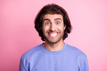 Fototapeta premium Photo of cheerful charming young man make beaming funky smile positive isolated on shine pastel pink color background