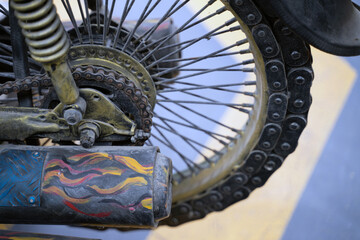 Close-up picture of the art of the rear wheel of the motorcycle, the end of the paint pipe