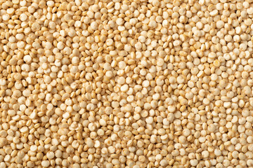 food background of raw quinoa, top view