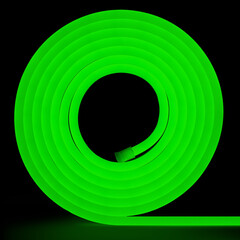 Green flexible glowing led tape neon in reel standing on black background