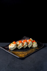 fried sushi  on the dark background