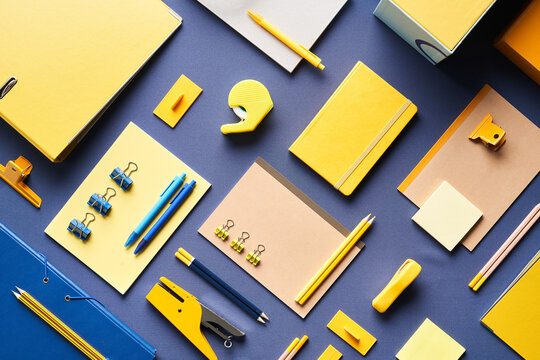 Various office supplies on blue background