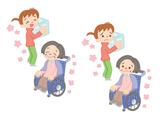 車椅子の女性と介護おむつを持つ女性