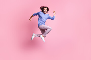 Fototapeta na wymiar Full size photo of young happy excited crazy positive good mood man jump in victory isolated on pink color background