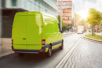 Green cargo van driving in the city