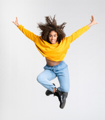 Young African American woman dancing over isolated white background