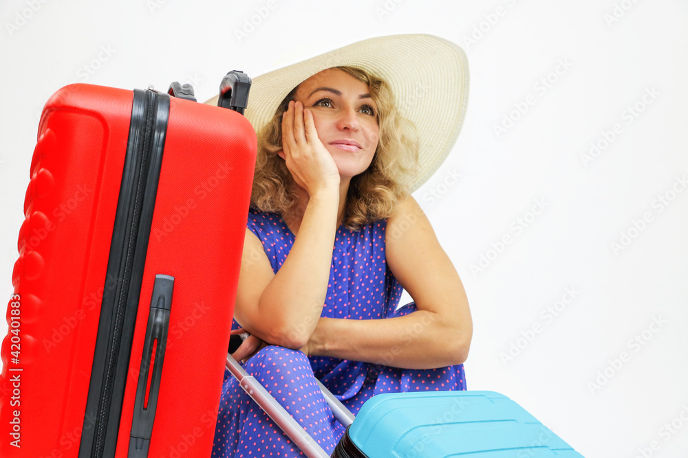 Wall mural girl in hat with suitcases dreams of a holiday trip