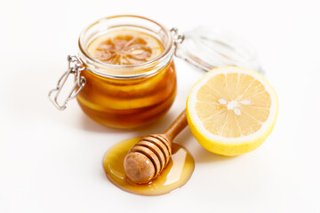 Lemon and honey on white stone background