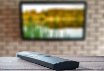 TV remote control on wooden surface