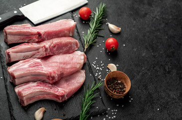 raw pork steaks on stone background with copy space for your text