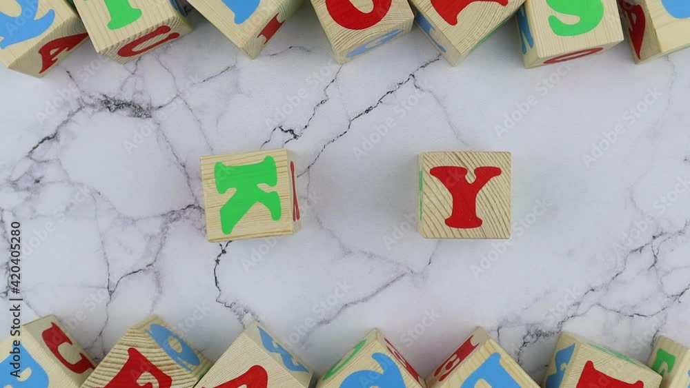 Fototapete sky concept with colorful alphabet letters on wooden cubes centered between top and bottom borders o