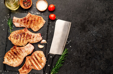 grilled pork steaks on stone background with copy space for your text