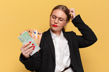 young pretty woman. thinking or doubting expression euro banknotes concept