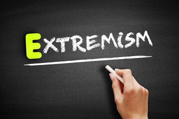 Extremism text on blackboard, concept background