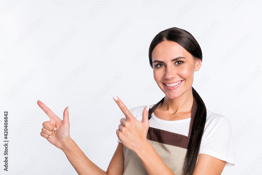 Sticker Photo of charming cheerful lady indicate fingers empty space have good mood isolated on white color background