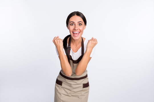 Portrait of delighted positive girl fists up open mouth shout yes celebrate isolated on white color background
