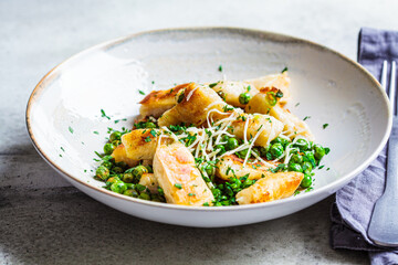 Gnocchi with peas, cheese and herbs. Italian cuisine concept.