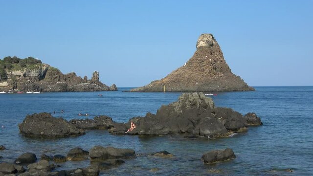 View of the Faraglioni of Acitrezza. Rocks of the Cyclops, typical lava stacks. Sicily, Italy. Footage 4k