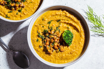 Lentil cream soup with broccoli and dill in gray bowl, top view. Healthy vegan food concept.