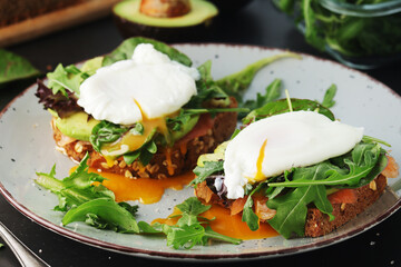 Homemade sandwiches with salmon, avocado and poached eggs