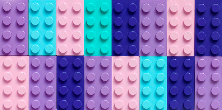 Many toy blocks in different colors making up one large square shape in top view. Toys and games. Leisure and recreation.	