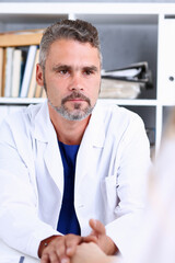 Fototapeta premium Friendly male doctor hold female arm in office