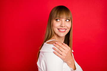 Profile side photo of young woman happy positive smile look empty space hand touch shoulder isolated over red color background