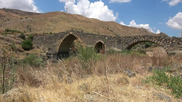 Medieval bridge of Adrano, Sicily, of arabic origin and saracen. Called Simeto river  lava gorges. Video 4k