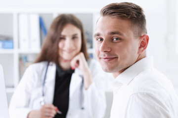Satisfied happy handsome smiling male patient with doctor