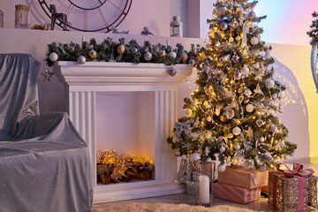 Cozy sofa and Christmas tree in the living room. The background of the photo studio. Photo shoot location in New Year
