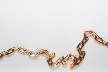 Gold modern massive chain necklace on light background. Space for text.