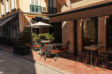 Sunlight on tables and chairs of cafe near sidewalk in Istanbul, Turkey