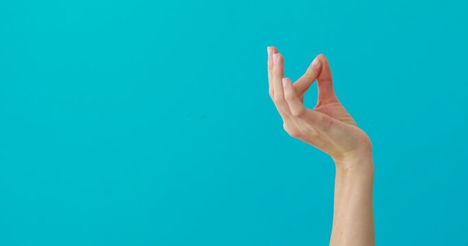 Fingers of the hand of a hand folded into a pinch