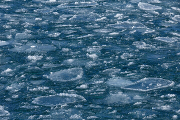 Ice blocks floating in water of Baikal lake in December
