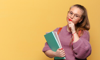 young pretty woman. thinking or doubting expression. student concept