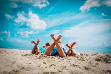 father with son and daughter relax on beach