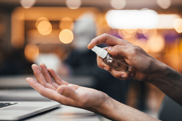 close up. man uses an antiseptic hand spray.