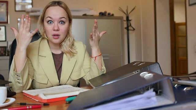 A lot of Paperwork and sad woman. Bored sad worker tired unmotivated and disinterested in dull work with laptop paperwork. Office clerk working, adding folders more work.