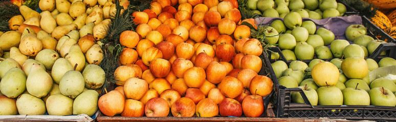 Ripe apples and pears on stall on street, banner