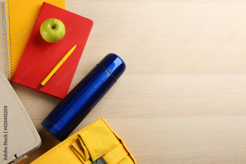 Sticker Flat lay composition with thermos and lunch box on wooden background, space for text