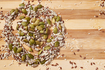 Seeds and grains on a wooden board. Healthy eating. Close-up, macro
