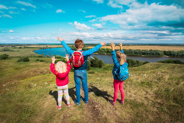 happy kids travel in nature, boy and girls enjoy scenic view