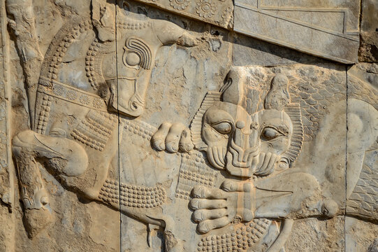 Famous bas relief carving of a lion hunting a bull at the ruins of Persepolis, a UNESCO world heritage site in Iran
