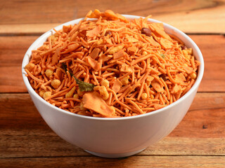 Indian traditional Namkeen Food Mixture or Navratna Mix Namkeen Also Know as Nimco, Namkin, Mixture ,chiwda or Nimko. Served in a bowl. selective focus