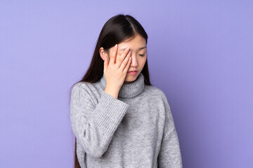 Young asian woman over isolated background with headache