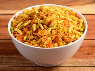 Indian traditional Namkeen Food Mixture or Navratna Mix Namkeen Also Know as Nimco, Namkin, Mixture ,chiwda or Nimko. Served in a bowl. selective focus