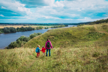 Fototapeta na wymiar mother and kids travel in nature, family hiking
