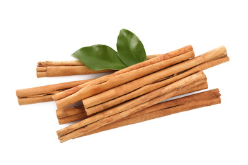 Aromatic dry cinnamon sticks and green leaves on white background, top view
