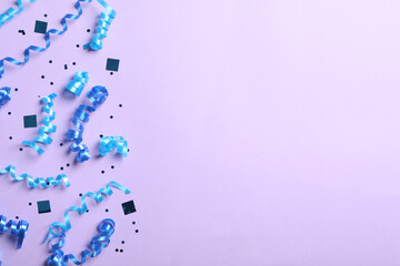 Blue serpentine streamers and confetti on light background, flat lay. Space for text
